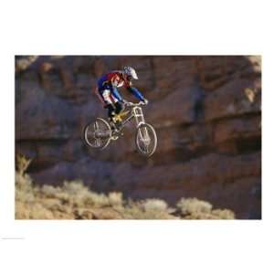 Side profile of a person on a bicycle in mid air Poster (24.00 x 18.00 