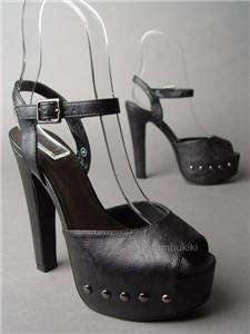   towering high heel. Faux leather upper. Peep toe front. Adjustable