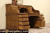   about 1900 this roll top desk has raised panels and a smooth gliding s