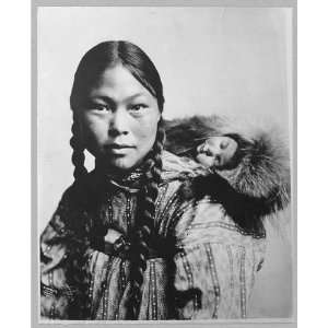 Eskimo mother with child on back 