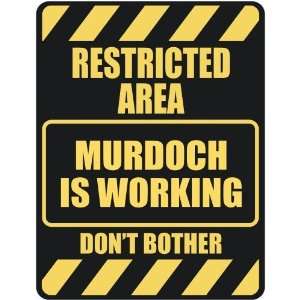   RESTRICTED AREA MURDOCH IS WORKING  PARKING SIGN