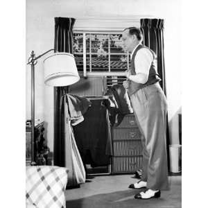 Writer Damon Runyon Trying on Vest with Open Wardrobe Trunk and Other 